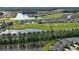 Aerial view of the community golf course and lake, providing a picturesque view and recreational opportunities at 349 Caryota Ct, New Smyrna Beach, FL 32168
