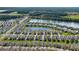 A captivating aerial view of a well-planned community with waterfront homes and meticulously maintained green spaces at 349 Caryota Ct, New Smyrna Beach, FL 32168
