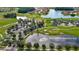 Aerial view of The Club at Venetian Bay, surrounded by lush greenery and a tranquil lake at 349 Caryota Ct, New Smyrna Beach, FL 32168