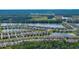 An aerial view of the community's lake and clubhouse, offering a scenic and recreational lifestyle at 349 Caryota Ct, New Smyrna Beach, FL 32168