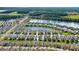 Stunning aerial view of the community with beautiful homes and a serene lake at 349 Caryota Ct, New Smyrna Beach, FL 32168