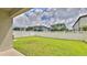 Spacious backyard with a well-kept lawn and white picket fence, offering privacy and room for recreation at 349 Caryota Ct, New Smyrna Beach, FL 32168