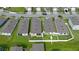Aerial view of a well-manicured backyard with lush grass and a patio at 349 Caryota Ct, New Smyrna Beach, FL 32168