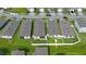 Aerial view of a well-manicured backyard with lush grass and a patio at 349 Caryota Ct, New Smyrna Beach, FL 32168