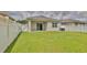 Lush backyard with healthy lawn and complete white fencing offering privacy and beauty at 349 Caryota Ct, New Smyrna Beach, FL 32168