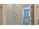Modern bathroom with a glass-enclosed shower and a view of the bedroom through an open doorway at 349 Caryota Ct, New Smyrna Beach, FL 32168