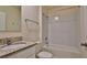Bathroom with granite countertop vanity, mirror, and bathtub with tile surround at 349 Caryota Ct, New Smyrna Beach, FL 32168