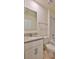Bathroom with granite countertop vanity, mirror, and bathtub with tile surround at 349 Caryota Ct, New Smyrna Beach, FL 32168