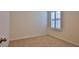 Carpeted bedroom featuring neutral walls and a window with plantation shutters at 349 Caryota Ct, New Smyrna Beach, FL 32168