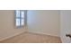 Bedroom featuring neutral carpet and walls and a window with plantation shutters at 349 Caryota Ct, New Smyrna Beach, FL 32168