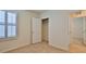 Bedroom with neutral walls and carpet, featuring a closet and a window with plantation shutters at 349 Caryota Ct, New Smyrna Beach, FL 32168