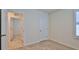 Bedroom featuring neutral carpet and a window with plantation shutters at 349 Caryota Ct, New Smyrna Beach, FL 32168