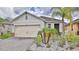 Well-maintained home boasts a two-car garage, neatly landscaped front yard with attractive curb appeal at 349 Caryota Ct, New Smyrna Beach, FL 32168