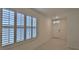 Foyer featuring tile flooring, a white front door, and a window with plantation shutters at 349 Caryota Ct, New Smyrna Beach, FL 32168