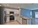 Modern kitchen with stainless steel appliances, white cabinets, and granite countertops for a sleek look at 349 Caryota Ct, New Smyrna Beach, FL 32168