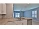 Eat-in kitchen featuring white cabinets, stainless appliances, and granite counters at 349 Caryota Ct, New Smyrna Beach, FL 32168