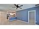 Open-concept living space with tile flooring, modern paint, and kitchen featuring stainless steel appliances at 349 Caryota Ct, New Smyrna Beach, FL 32168