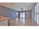 Spacious living room featuring tile floors, ceiling fan, and sliding glass doors with natural light at 349 Caryota Ct, New Smyrna Beach, FL 32168