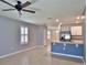 Bright, inviting living area with tile flooring, ceiling fan, and an eat-in kitchen with stainless appliances at 349 Caryota Ct, New Smyrna Beach, FL 32168