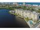 Waterfront condo building with lush landscaping, private pool, and ocean views in a coastal community at 3606 S Peninsula Dr # 406, Port Orange, FL 32127