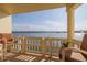 Inviting balcony seating area with scenic views of the surrounding water and clear blue skies at 3606 S Peninsula Dr # 406, Port Orange, FL 32127