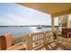 Spacious balcony with comfortable seating and stunning panoramic views of the water and bridge at 3606 S Peninsula Dr # 406, Port Orange, FL 32127