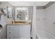 Well-lit bathroom featuring a vanity with ample storage, a large mirror, and a shower-tub combination at 3606 S Peninsula Dr # 406, Port Orange, FL 32127