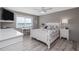Bright bedroom with white furniture, coastal decor, and a large window showcasing water views at 3606 S Peninsula Dr # 406, Port Orange, FL 32127