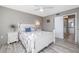 Comfortable bedroom featuring coastal-themed decor, soft lighting, and access to an ensuite bathroom at 3606 S Peninsula Dr # 406, Port Orange, FL 32127