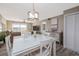 Bright dining area with modern white table and chairs, complemented by scenic water views at 3606 S Peninsula Dr # 406, Port Orange, FL 32127