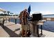 Community grill area with waterfront views and lounge seating under a partly cloudy sky at 3606 S Peninsula Dr # 406, Port Orange, FL 32127