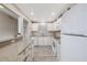 Bright white kitchen with ample storage, tile backsplash, and stainless steel appliances at 3606 S Peninsula Dr # 406, Port Orange, FL 32127