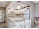 Updated kitchen with white cabinets, stone countertops, breakfast bar, and modern appliances at 3606 S Peninsula Dr # 406, Port Orange, FL 32127
