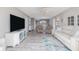 Open living room featuring neutral tones, ceiling fan, vinyl wood flooring, and views of dining area at 3606 S Peninsula Dr # 406, Port Orange, FL 32127