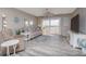 Living room features a ceiling fan, waterfront views, and sliding glass doors to the balcony at 3606 S Peninsula Dr # 406, Port Orange, FL 32127
