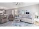 Bright living room with neutral furniture, ceiling fan, vinyl wood flooring, and modern decor at 3606 S Peninsula Dr # 406, Port Orange, FL 32127