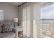 Cozy living area with neutral tones and sliding glass doors opening to a serene water view at 3606 S Peninsula Dr # 406, Port Orange, FL 32127