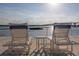 Patio area with lounge chairs and waterfront views under a partly cloudy sky at 3606 S Peninsula Dr # 406, Port Orange, FL 32127