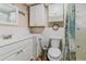 Bright white bathroom with tub/shower combo and storage at 3700 S Atlantic Ave # 108, New Smyrna Beach, FL 32169