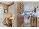 Inviting hallway showcasing a built-in desk, coastal decor and leading to the spacious living area at 3700 S Atlantic Ave # 108, New Smyrna Beach, FL 32169