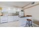 Charming eat-in kitchen features white cabinets, tile backsplash, modern appliances and a breakfast bar at 3700 S Atlantic Ave # 108, New Smyrna Beach, FL 32169