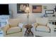 Inviting living room featuring comfortable seating, a decorative lamp, and American flag wall decor at 3700 S Atlantic Ave # 108, New Smyrna Beach, FL 32169