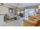Comfortable living room with tile flooring, a ceiling fan, a slider to the outside, and a cozy seating area at 3700 S Atlantic Ave # 108, New Smyrna Beach, FL 32169