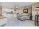 Open-concept living room and kitchen with tile flooring, plenty of seating, and a breakfast bar at 3700 S Atlantic Ave # 108, New Smyrna Beach, FL 32169
