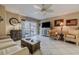 Relaxing living room features comfortable seating, coastal decor and a sliding glass door to the outside balcony at 3700 S Atlantic Ave # 108, New Smyrna Beach, FL 32169