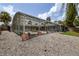 A large backyard with the rear of the home and enclosed pool in the background at 38 Fairway Cir, New Smyrna Beach, FL 32168