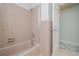 A bathtub with shower combination in a bathroom with pink tiling at 38 Fairway Cir, New Smyrna Beach, FL 32168