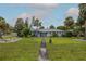 Inviting single-story home with a lush front yard and walkway, perfect for a relaxed lifestyle at 38 Fairway Cir, New Smyrna Beach, FL 32168