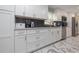 Well-lit kitchen showcasing white cabinets, subway tile backsplash, stainless steel appliances, and marble floors at 38 Fairway Cir, New Smyrna Beach, FL 32168