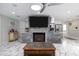 Inviting living room featuring a unique stone fireplace and open layout to the kitchen at 38 Fairway Cir, New Smyrna Beach, FL 32168